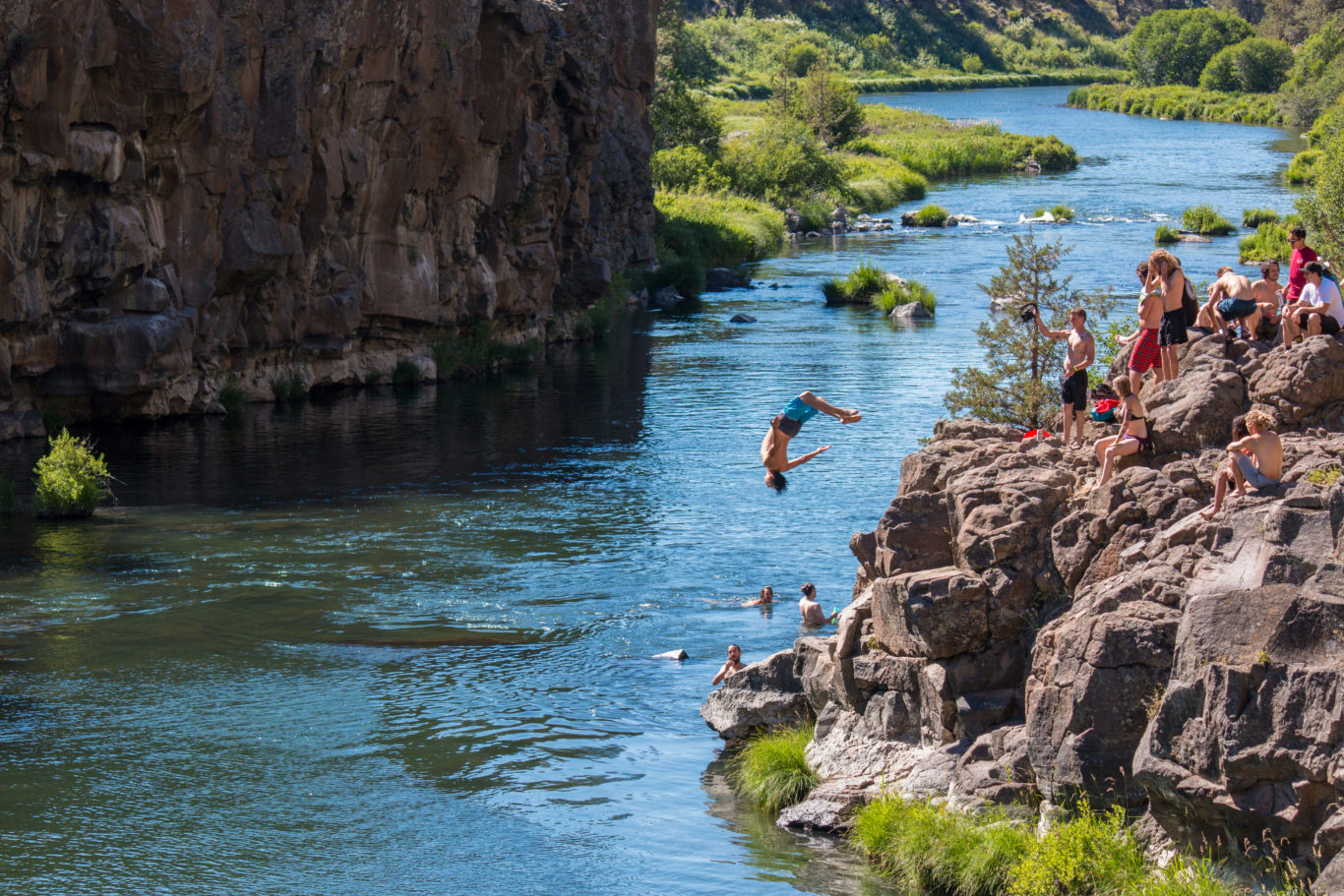 Victor Arias backflips into the river in Oregon - Photograph by Erick Garcia